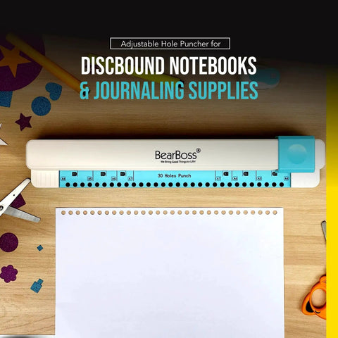 Adjustable 30 Hole Discbound Hole Punch for Custom Planners and Notebooks on wooden table with paper and crafting supplies