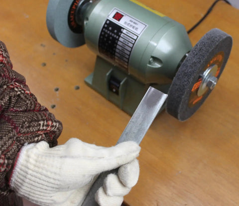 Person using a bench grinder with Deburring Nylon Fiber Buffing Wheel 6 Inch For Bench Grinder Polishing Machine With Silicon Carbide Abrasive