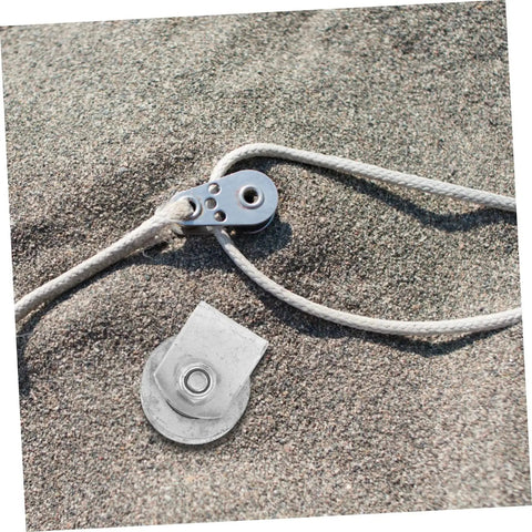 Heavy Duty V Groove Wheel Pulley Caster For Sliding Gates And Garage Doors With Cast Iron Wheel lying on sandy surface with rope