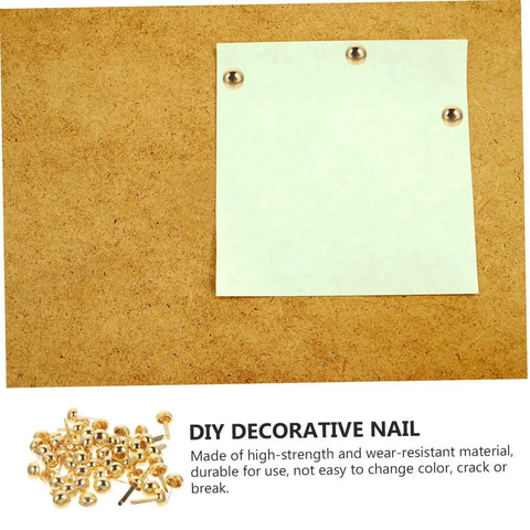 100 Pieces Decorative Craft Nails For DIY Projects shown securing paper on wood surface