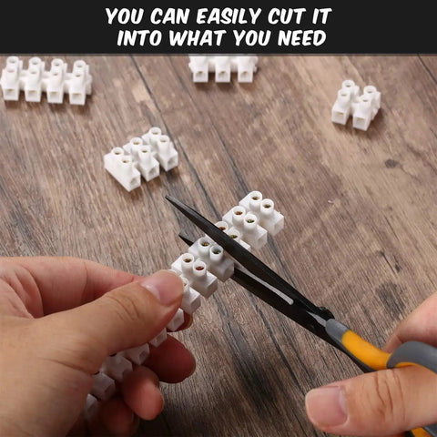 Person cutting 10 Piece White Terminal Blocks With 12 Position Dual Row Screw Terminals For Easy Wire Connection 4 Mm2 Wire Gauge 20 Amp 380V Durable Flame Retardant Plastic Shell Great For DIY Electronics And Electrical Projects on wooden surface