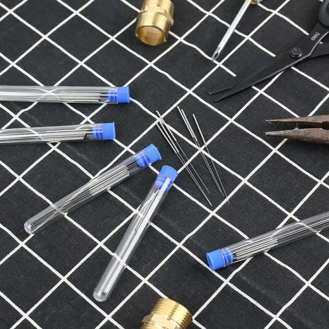 Bulk 50 Pieces 0.4 mm Stainless Steel 3D Printer Nozzle Cleaning Kit With Storage Bottles, needles and tools on grid surface