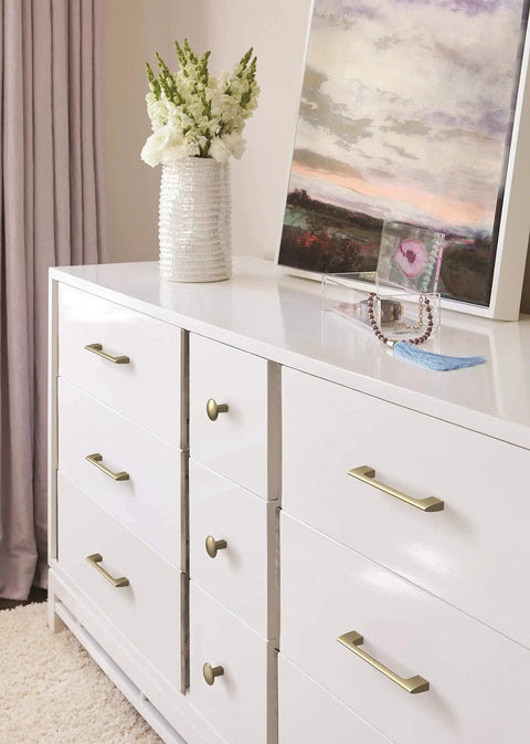 Golden Champagne Riva Cabinet Pull 5 1/16 Inch Center To Center 5 11/16 Inch Overall Length on white dresser