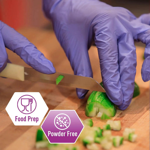Person wearing Powder Free Nitrile Exam Gloves Iris Blue Medium Box Of 100 For Medical Labs Hospitals And Professional Use slicing cucumber.