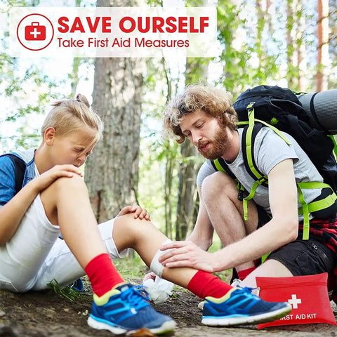 Man using Compact 97 Piece Travel First Aid Kit for Cars Home School Sports Camping And Hiking on boy's leg in forest
