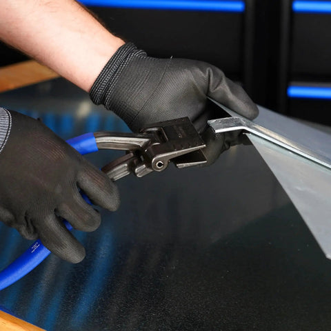 Person using Offset 3 Inch Seamer Tong For Sheet Metal Bending And Forming With One And Quarter Inch Throat Depth Ideal For HVAC Auto Repair And Home Improvement Midwest Made In USA MWT ST2 And Durable Build to bend metal sheet on workbench.