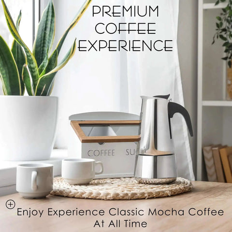 Stovetop Espresso Maker 9 Cup Moka Pot In Stainless Steel 450ml 15oz on a wooden table near two mugs