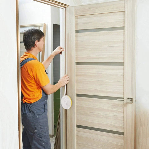 Person installing Door And Window Weather Stripping For No More Drafts And Maximum Noise Reduction, Soundproof Insulation, Self Adhesive Rubber Seal Strip, 16.5 Ft White, Easy Fit And Durable, By CloudBuyer on a wooden door.