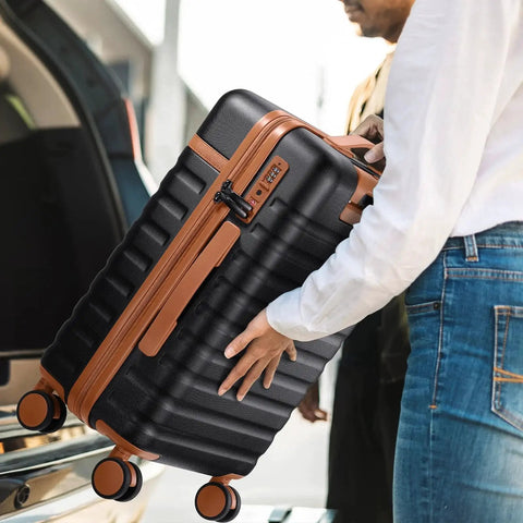 Person lifting Three Piece Luggage Set With 20 Inch Carry On Spinner Wheels PC Hardside Suitcase TSA Lock Durable Travel Setup near car trunk.
