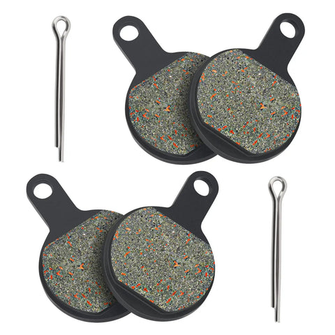 Front view of four Tektro IOX disc brake pads with mounting tabs and two metal pins.