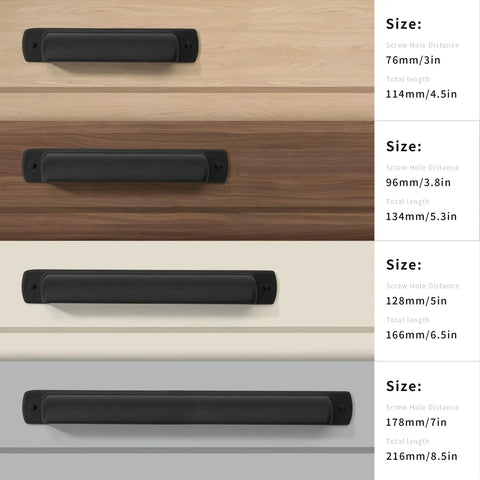 Four matte black cup drawer pulls in varying sizes displayed on wood surfaces with dimensions labeled on the right.
