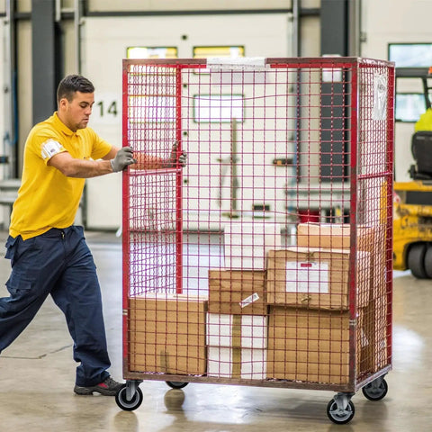 Warehouse worker pushing a large red wire cage cart on heavy duty 5 inch swivel caster wheels set of 4 with 1400 lb load capacity.