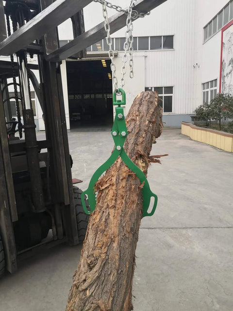 Log Lifting Tongs With Two Serrated Swivel Claws 32 Inch Opening lifting log with a forklift in industrial yard.