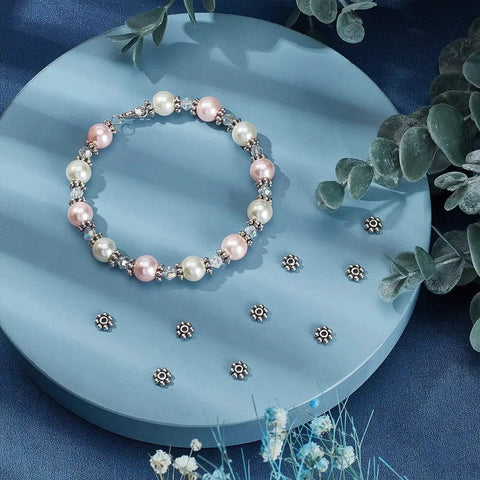 Bracelet with Antique Silver Daisy Flower Spacer Beads 6mm 300Pcs Tibetan Style Alloy Spacer for Jewelry Making on blue background