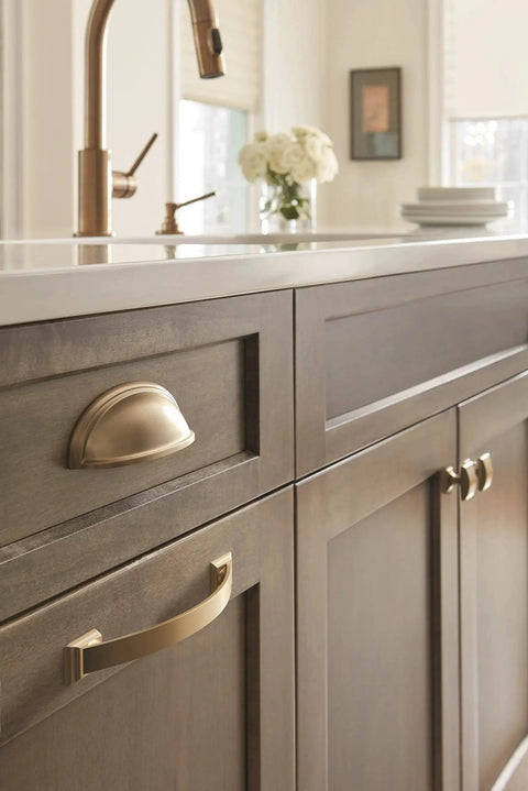 Kitchen cabinet featuring Golden Champagne Ashby Cabinet Cup Pull for 3 Inch Center To Center and 4 Inch Center To Center Spacing