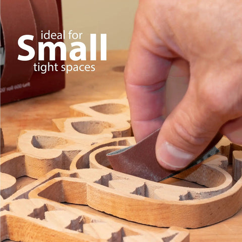 Person sanding wood carving with Emery Cloth Roll Sandpaper Dispenser With Pro Grade Boxed Multi Roll Tear Off Design.