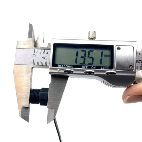 Measuring Five Piece M12 Connector Dust Covers For Female Sockets Protective Caps with caliper showing 13.51mm size