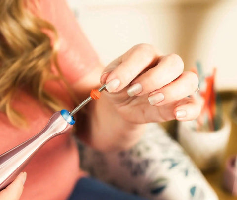 Person using Quilling Bead Roller Tool Set with Slotted Winding Pins in Three Sizes for DIY paper jewelry making.