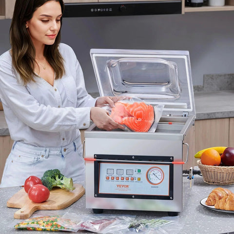 Woman using Chamber Vacuum Sealer For Wet Foods And Meats Powerhouse 320W Sealing, 100KPa Quick Vacuum, in kitchen with food.