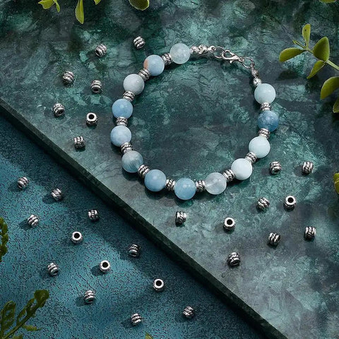 Antique Silver Tube Spacer Beads 300 Pcs Tibetan Zinc Alloy 4x5mm With 2.2mm Hole for bracelet jewelry making on blue background