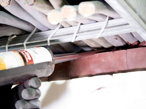 Applying Barrier FIP 1-Step Intumescent Firestop, 2-Hour UL/CAN Listed, Maroon, sag-resistant foam on cable penetrations.
