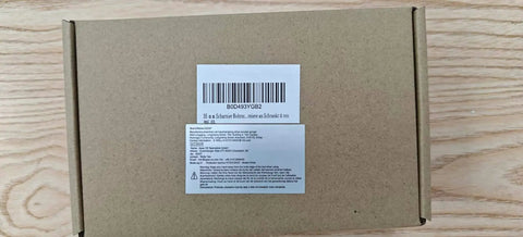 Top view of closed cardboard box on wooden surface with barcode and label