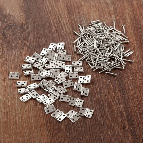 Miniature Brass Hinges Set With 20 Pieces 1 x 0.8 Cm Folding Butt Hinges Plus 80 Replacement Nails spread on wooden surface