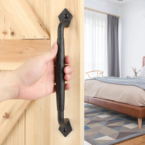 Rustic 12 Inch Barn Door Handle Heavy Duty Pull For DIY Sliding Doors Gates Sheds And Garages Round Solid Metal With Matte Black Finish Built To Stand Up To Everyday Use And Easy Mounting installed on wooden door with hand.