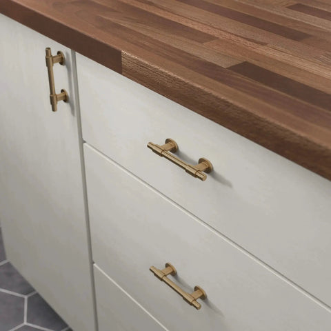 Champagne Bronze Cabinet Hardware Set 5 Pack Adjustable Drawer Pulls installed on white kitchen cabinets with wood countertop