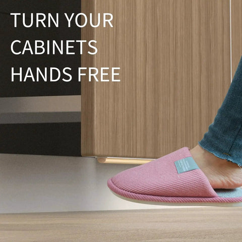 Person using Trash Cabinet Foot Pull Hands Free Foot Pedal Opener for Drawers Bins and Cabinets in a modern kitchen.
