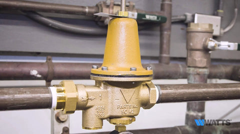 Watts LF25AUB-Z3 water pressure reducing valve, NPT female unions, 3/4in brass body with yellow bonnet.