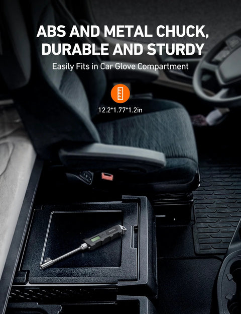 AstroAI digital tire pressure gauge, black with backlit LCD and stainless steel probe, placed in car center console.