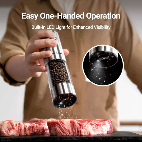 Upgraded Large Capacity Electric Salt And Pepper Grinder Set in use, grinding pepper onto raw meat with LED light and stainless steel finish.