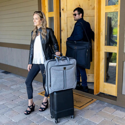 Travelers with Premium Suit Garment Bag for Travel and Business, over shoulder strap, hangs four suits, ZEGUR design, outdoor scene