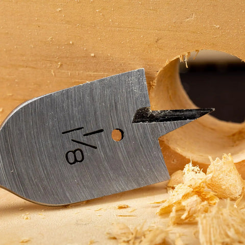 Close-up of Three Piece Spade Drill Bit Set Three Quarter Inch Paddle Flat Bits For Woodworking with clean wood hole