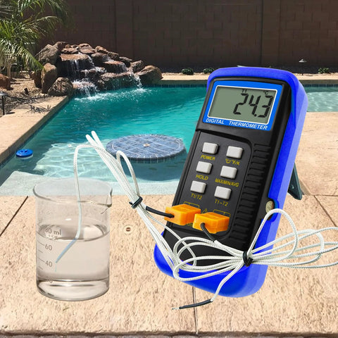 Digital K-type dual-channel thermometer in a blue protective case with four thermocouples; LCD reads 24.3°C beside a beaker by the pool.