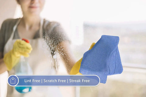 Blue 12x14 Inch Shop Towels Pack Of 50 Plus 5 Bonus Reusable Cleaning Rags for cleaning a window, showing absorbency and durability