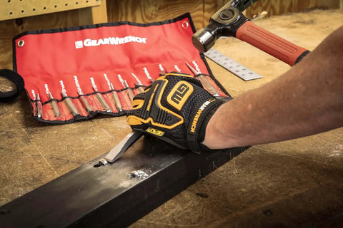 Using the 12 Piece Punch And Chisel Chrome Set For Pros And DIYers, cutting rivets on metal, red tool roll in background