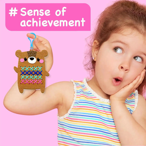 Child holding completed project from Beginner Needlepoint Cross Stitch Kit For Kids Ages Five To Eight, with bear pattern.