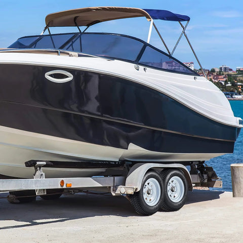 Boat on a trailer with a Trailer Tire And Wheel Set With ST175/80D13 Tire On 13 Inch Rims, 5 Lug On 4.5 Inch Bolt Pattern, Load Range C, 6PR, 50 Psi Max, White 13x5 Wheels, Set Of 2 near water.
