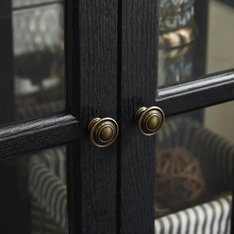 Close-up of black wood grain lattice doors with brass knobs on a 30 Inch Glass Curio Display Cabinet With LED Lighting