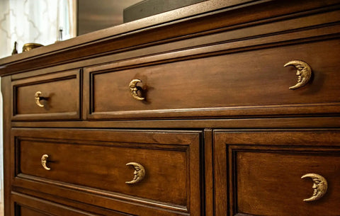 Set Of Six Gold Finish Cast Iron Crescent Moon Face Drawer Pulls For Celestial Decor installed on wooden dresser