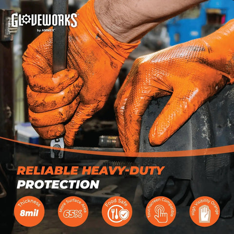 Close-up of hands wearing orange nitrile work gloves 8 mil heavy duty raised diamond grip 5 boxes, using tools in a workshop.