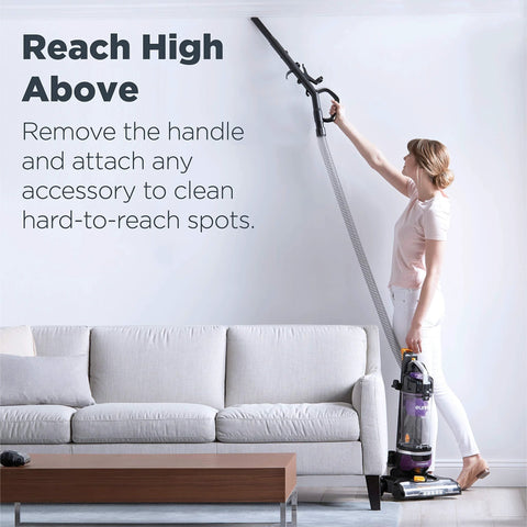 Eureka PowerSpeed NEU202 upright vacuum in purple with extension wand for hard-to-reach spots in living room.