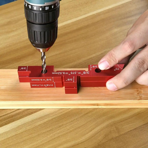 Close-up of Aluminum Setup Blocks 14 Piece Set With Case For Woodworking in use with a drill on wooden surface.
