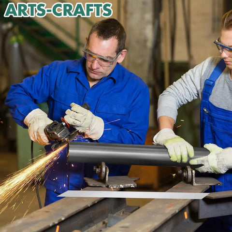 Two workers in safety gear using tools on metal pipe for crafting at arts-crafts workshop