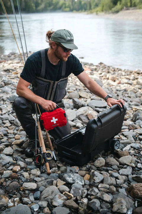 Man by a river using Heavy Duty Waterproof First Aid Box For Survivalists By Nanuk NK 7 Resin Case IP 67 Rated Dustproof Crushproof