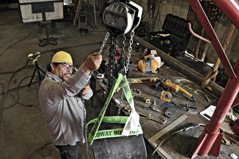 JET 1-Ton hand chain hoist with 20' lift, gray metal body, overhead mounted in workshop.