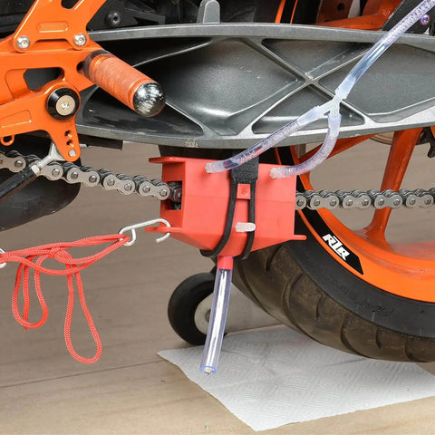 All Models Motorcycle Chain Cleaning Kit With Lube Device And Brush Gear Cleaner Tool For Chains, Easy Wash And Lubing Maintenance Accessory That Fits All Models And Bikes, Heavy Duty Red Finish installed on motorcycle chain with red finish.