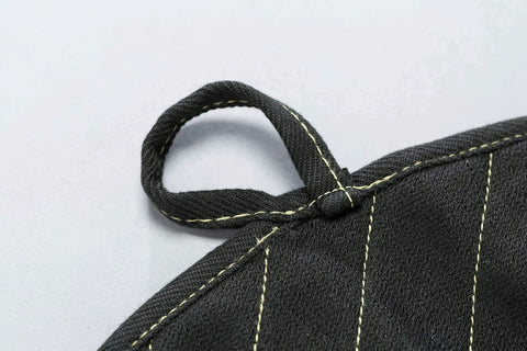 Close-up of X Pad Suppressor Handler for Tactical Duty Gear with CarbonX heat resistance, Kevlar stitching loop detail in black.